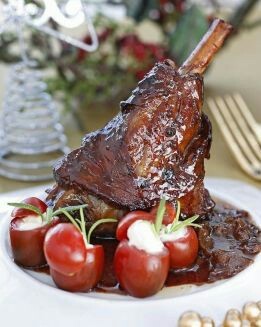 CANILLA DE CORDERO GLASEADA CON TOMATES RELLENOS